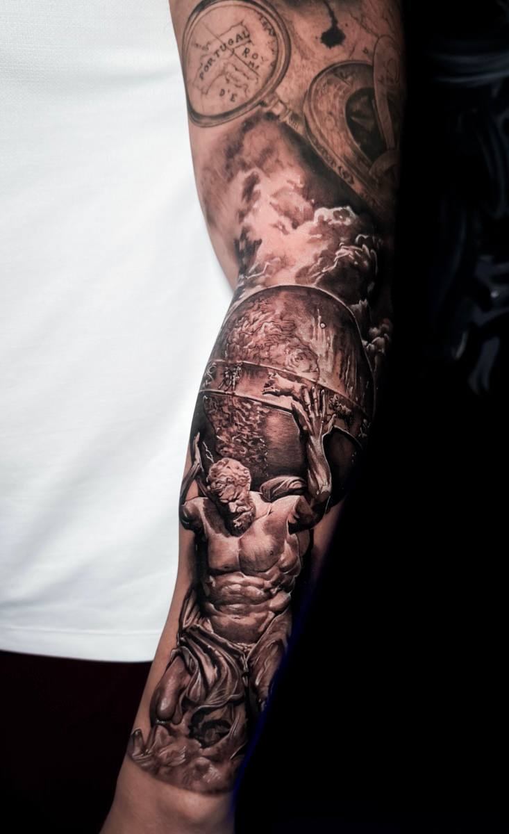 Black and grey atlas sleeve tattoo
