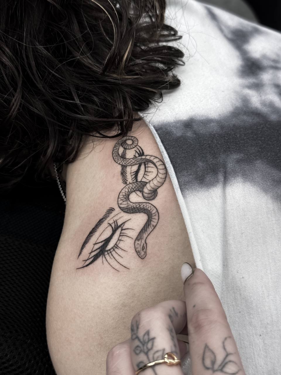 Fine line snake and eye tattoo