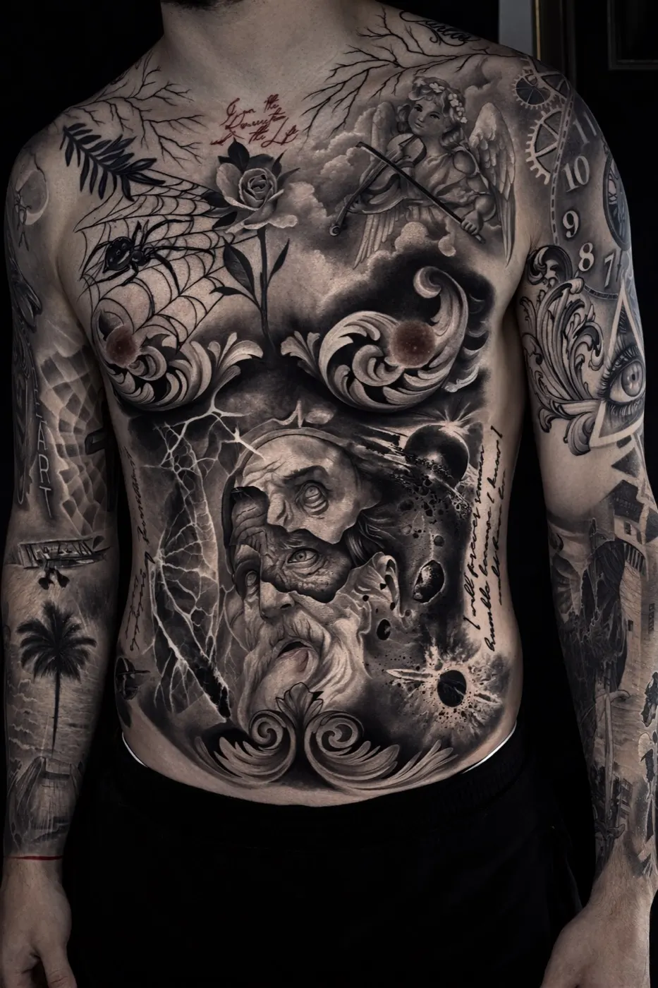 Black and grey torso tattoo featuring a bearded face, clouds, lightning and ornamental scrollwork — by Laurent Alba